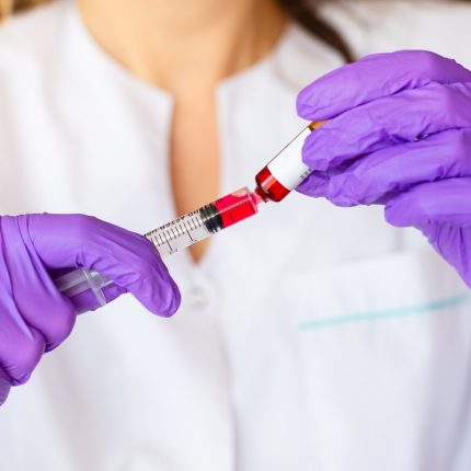 Woman hands holding syringe ampoule